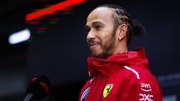 Lewis Hamilton talks into a mic