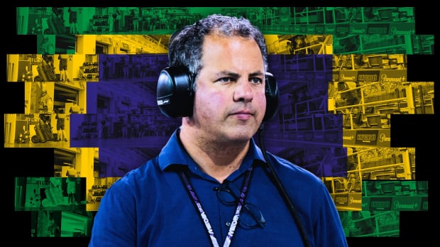 Kravitz looking serious with his F1 media lanyard and ear defenders on in front of a Brazilian-paddock themed background