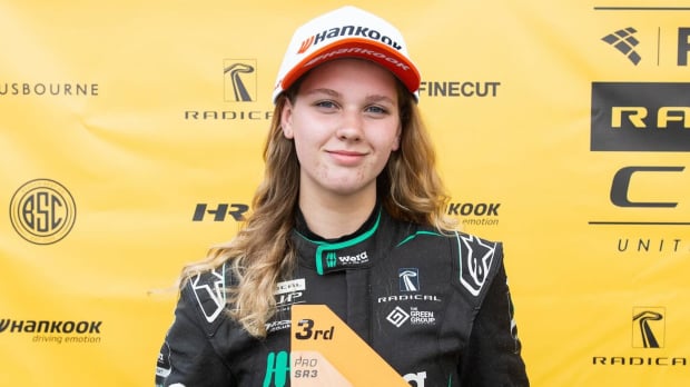 Rachel Robertson stands with a trophy after finishing third