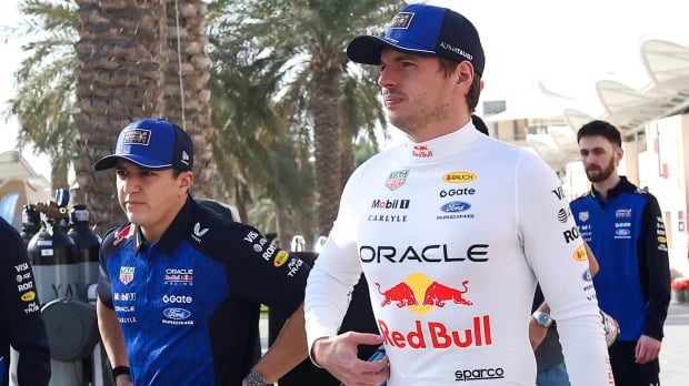 Max Verstappen and Isack Hadjar walking into the Bahrain paddock during pre season testing