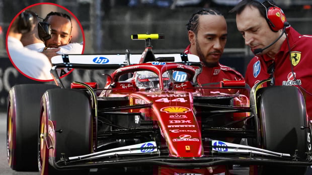 Lewis Hamilton drives his SF-25, flanked by a picture of him in talks with Adami on one side, and hugging Bono on the other