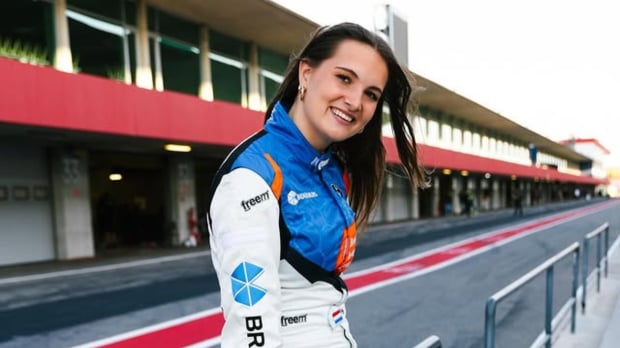 Esmee Kosterman poses for a photo trackside in a racing suit