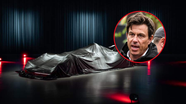 Toto Wolff looks on angrily as an under-wraps F1 car sits in the foreground