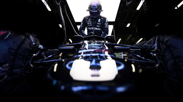 Lewis Hamilton steps into the cockpit of his Mercedes in Azerbaijan