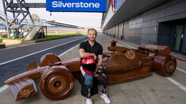 Billy Monger sits on the KitKat F1 car at Silverstone: Image credit: KitKat