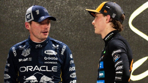 Piastri watching Verstappen talk after the Singapore GP 