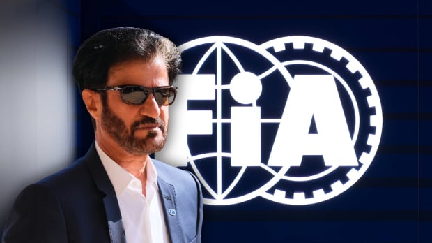 mohammed ben sulayem looking serious with sunglasses on in front of dark blue background and white FIA logo