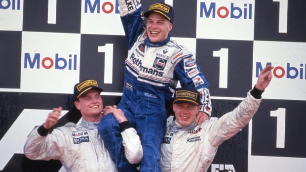 Mika Hakkinen and David Coulthard lift up Jacques Villeneuve after he becomes 1997 world champion — Photo: © IMAGO