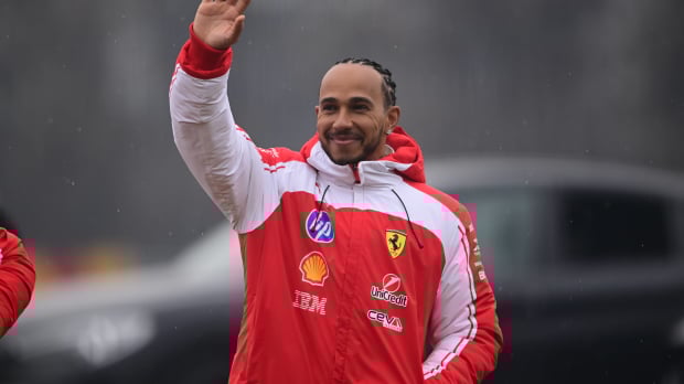 Lewis Hamilton waves to the crowd at Ferrari's shakedown