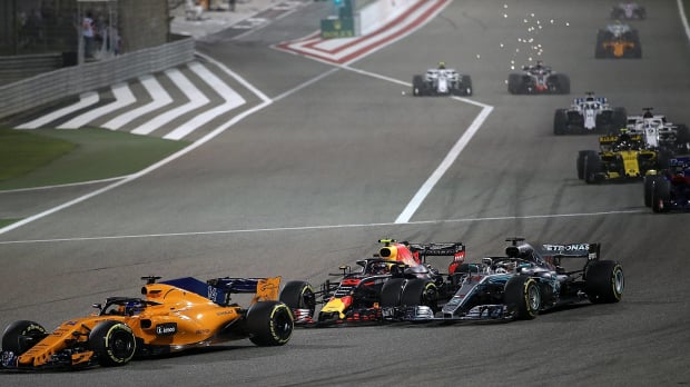 Max Verstappen makes a move on the inside of Lewis Hamilton at Turn 1 at the 2018 Bahrain Grand Prix