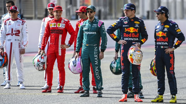 Drivers standing on the grid.