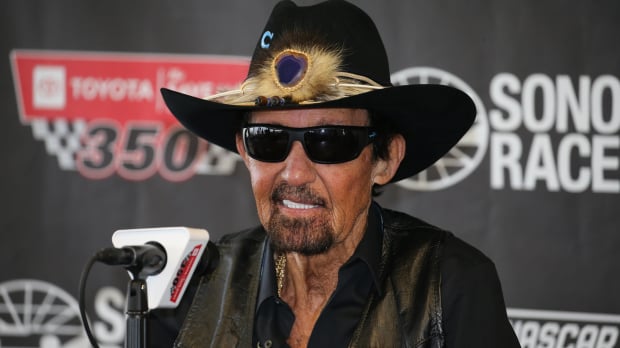 An image of NASCAR legend Richard Petty talking at a press conference