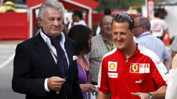 Michael Schumacher and manager Willi Weber discuss matters at the 2009 Spanish Grand Prix