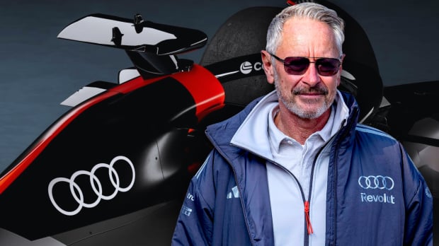 Wheatley in Audi F1 jacket in front of promotional Audi F1 car close up — Photo: © IMAGO