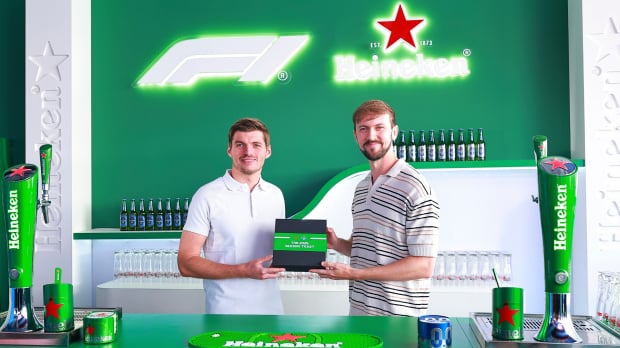 Max Verstappen presented the first F1 season ticket to superfan Brandon Burgess. Image Credit: Heineken