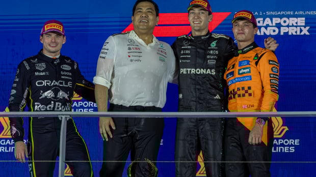 George Russell, Max Verstappen and Lando Norris stand on the Singapore Grand Prix podium 2025