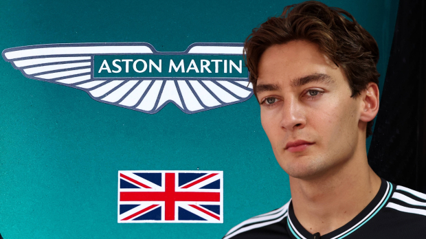 George Russell in front of an Aston Martin logo