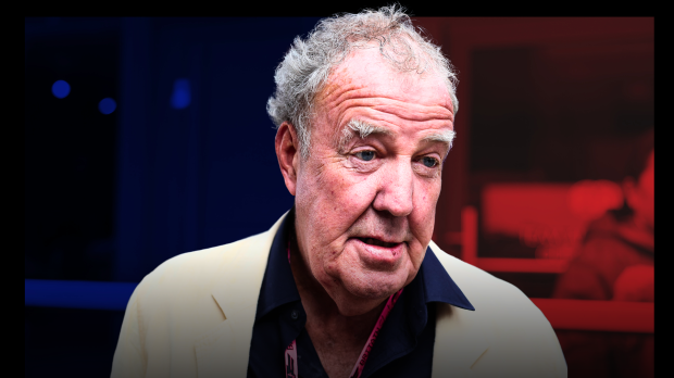 Jeremy Clarkson looking confused with a pink VIP F1 pass round his neck with a blue and red shadow background — Photo: © IMAGO