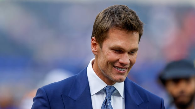 Tom Brady talks to fans before an NFL game