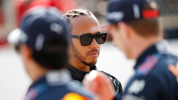 Hamilton flanked by the two Red Bull drivers 