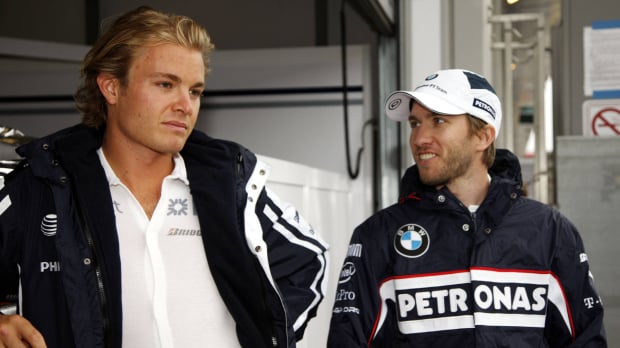Heidfeld smiling and looking inspired by Rosberg in 2009 at an F1 track