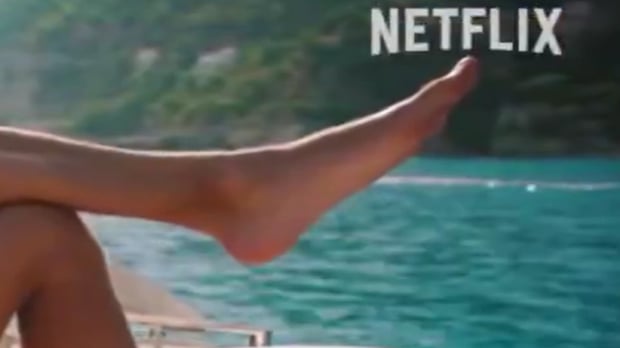 Screenshot from the DTS trailer of Russell's huge foot hanging over a boat, nearly taking up the whole screen with Netflix logo top right