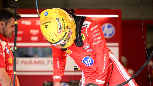 Lewis Hamilton climbs out of the SF-26 in the Ferrari garage at the Belgian GP — Photo: © IMAGO