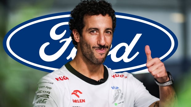 Daniel Ricciardo smiles and gives a thumbs up with the Ford logo in the background