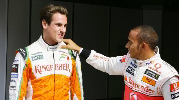 Sutil and Hamilton in 2009. Both in race suits and Sutil smiling while Hamilton rests his hand on Sutil's shoulder. 
