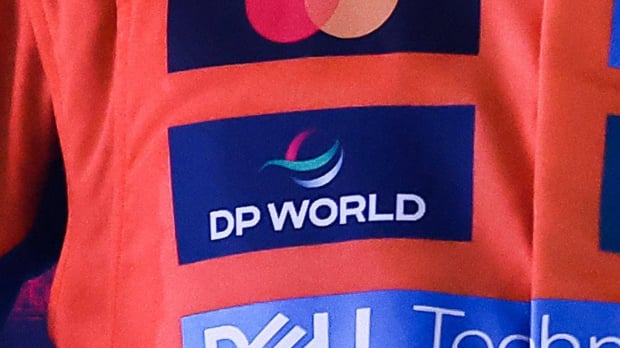 The DP World logo is seen on the McLaren racesuit
