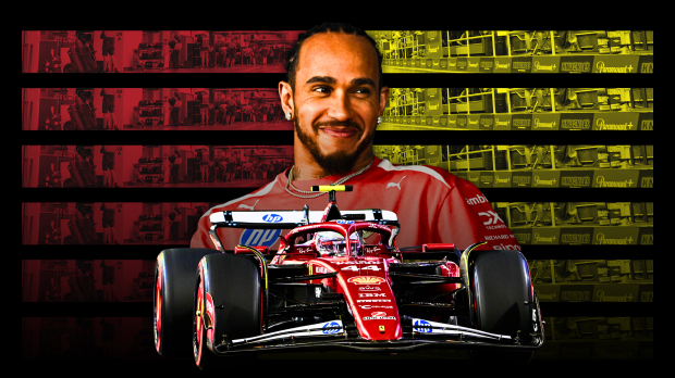Hamilton smiling in front of a red, black and yellow background with his Ferrari F1 car in the foreground — Photo: © IMAGO