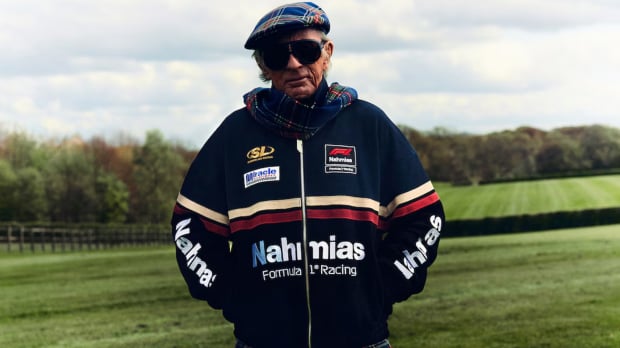 Image Credit: The F1 Store. Three-time champion Jackie Stewart wearing F1 X NAHMIAS