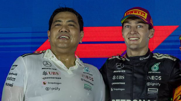 George Russell and Tengku, Muhammad Taufik Tengku Aziz celebrate on the Singapore Grand Prix podium 2025