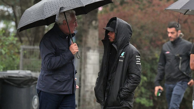 Lewis Hamilton speaking with Lawrence Stroll
