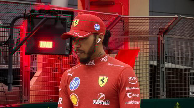 Lewis Hamilton looks sad in front of a red flag