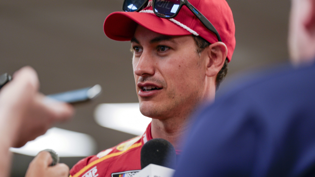 An image of NASCAR driver Joey Logano talking to the media