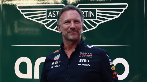Christian Horner in front of the Aston Martin logo