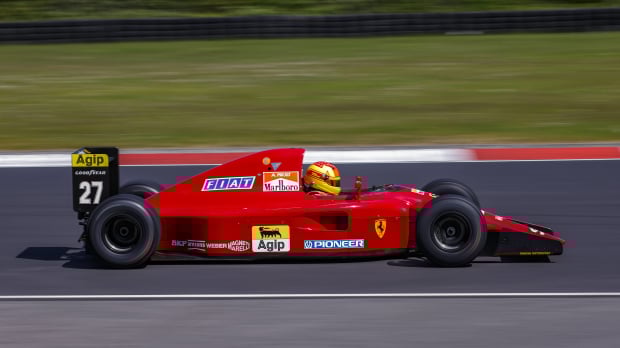 A 1992 Ferrari F1 car being driven around the Nurburgring track in 2023