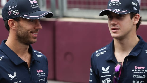 Pierre Gasly smiles at Franco Colapinto as they both stand in their Alpine team gear