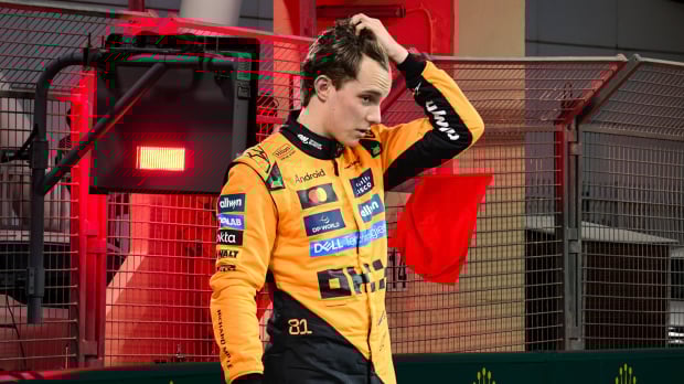 Oscar Piastri looks upset in front of a red flag