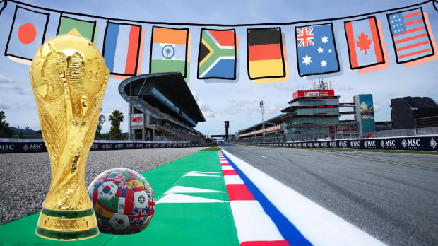 The FIFA world cup trophy and a ball sit on the tarmac at the Barcelona GP with a banner of flags above them — Photo: © IMAGO