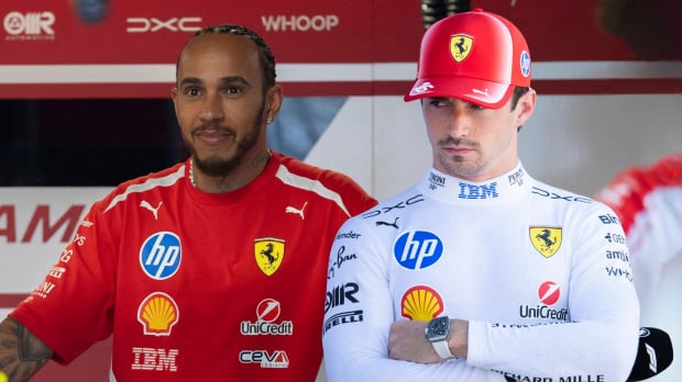 Hamilton smiling with grumpy Leclerc edited next to him in white Ferrari kit holding F1 microphone — Photo: © IMAGO