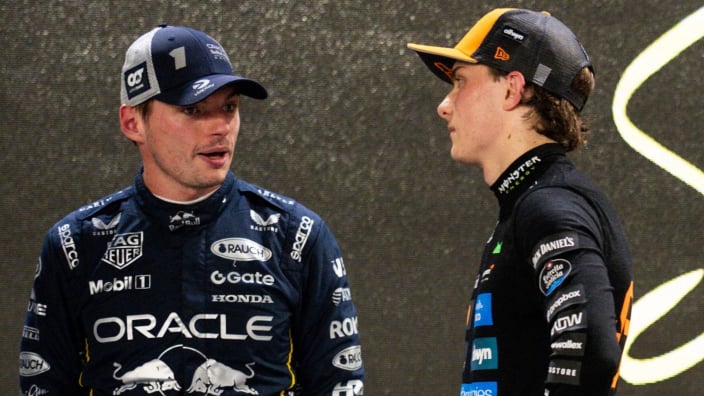 Piastri watching Verstappen talk after the Singapore GP