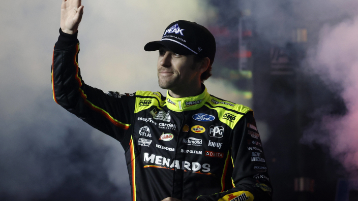 An image of NASCAR driver Ryan Blaney waving to the crowd at Daytona