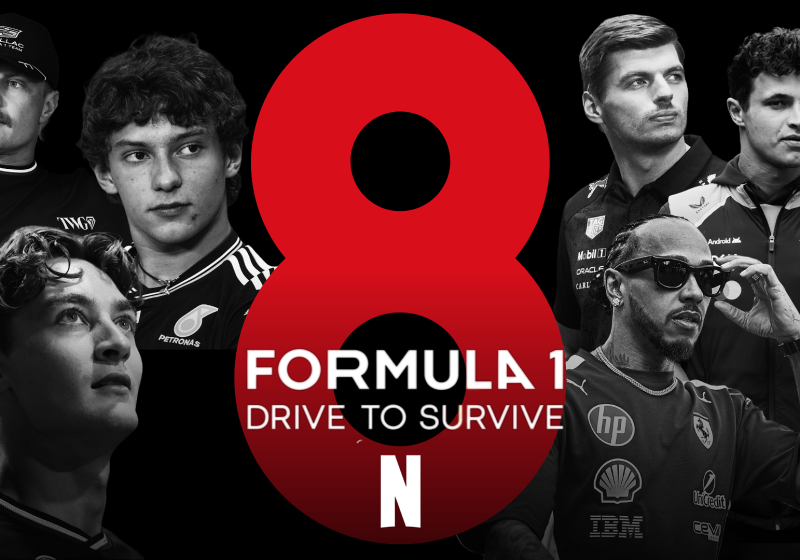 F1 drivers surround a sign showing the eighth season of Drive to Survive