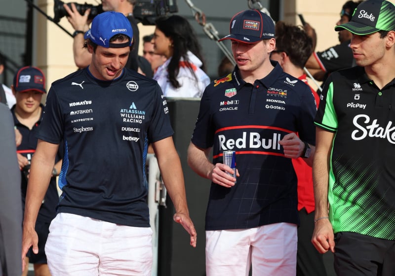 Sainz, Verstappen and Bortoleto walking together in the F1 paddock
