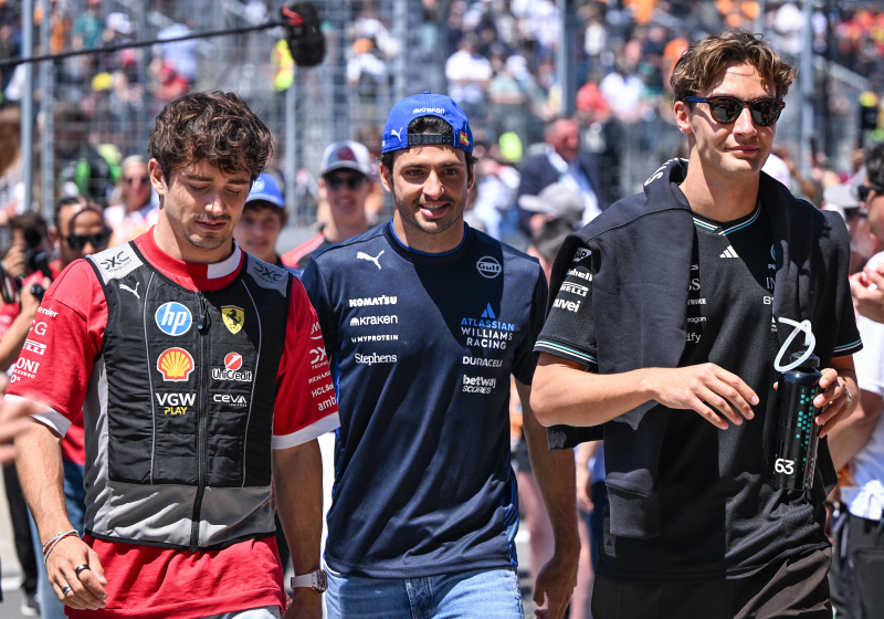 Charles Leclerc walks alongside Carlos Sainz and George Russell