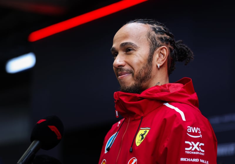 Lewis Hamilton talks into a mic