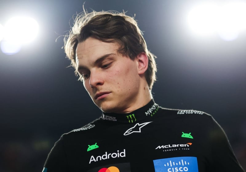 Zoomed in picture looking up at Piastri in black McLaren F1 kit