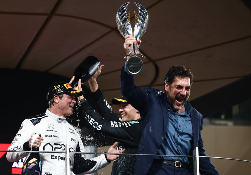 Javier Bardem and Brad Pitt celebrate on the F1 podium